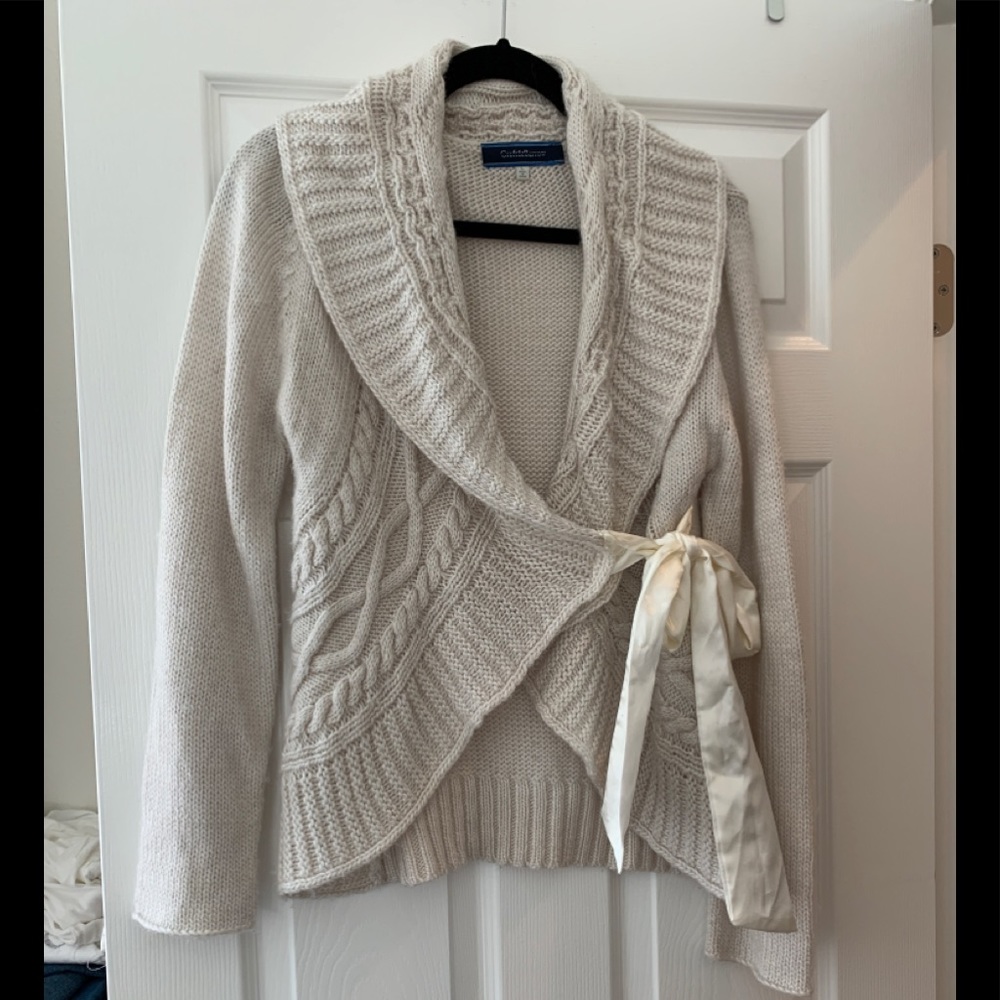 Sweater wrap style with satin ribbon tie.